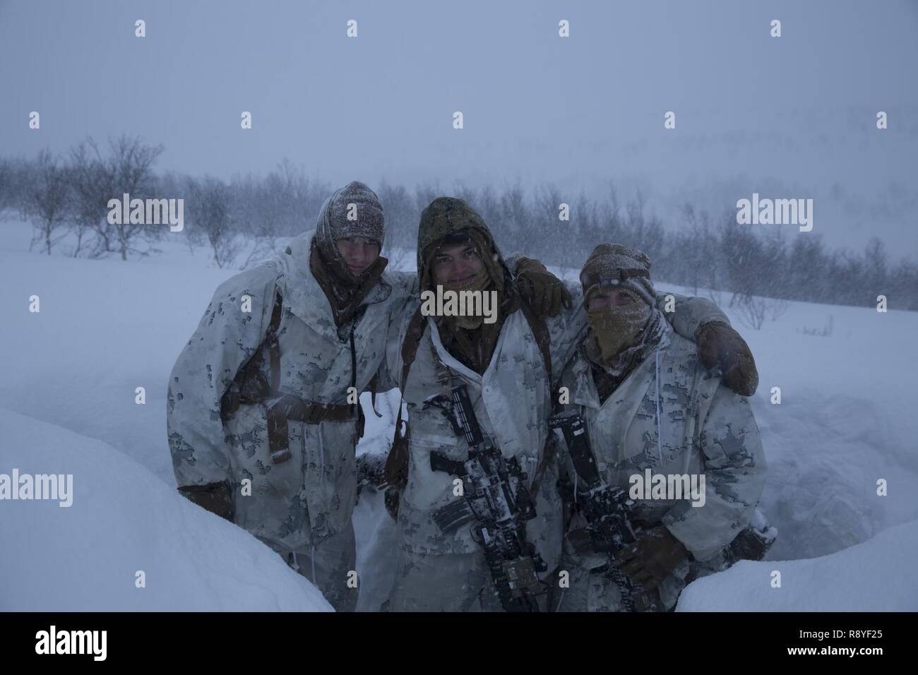 U.S. Marines Cpl. Conway Hughes, left, Cpl. Mason Siegel, middle, and Lance Cpl. Charles Pate, right, prepare to stand watch during a blizzard March 11, 2017, inside the Arctic Circle of Norway. Marine Rotational Force Europe 17.1 (MRF-E) participated in Exercise Joint Viking. No nation can confront today’s challenges alone, a principle embraced by U.S., U.K., Norwegian, and Dutch forces who participated in the exercise. Hughes, Siegel and Pate are riflemen with 1st Platoon, MRF-E. Stock Photo