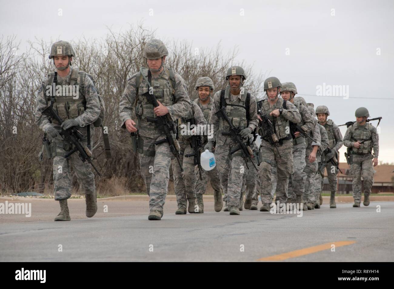 U.S. Airmen assigned to the 7th Security Forces Squadron march to the Combat Arms Training and Maintenance range to begin the Top Defender Challenge March, 11, 2017, at Dyess Air Force Base, Texas. The event consists of firing, written test, room clearing, shoot, move and communication drill, self-aid and buddy care and a resupply mission to determine the best two-man team in the squadron. Stock Photo
