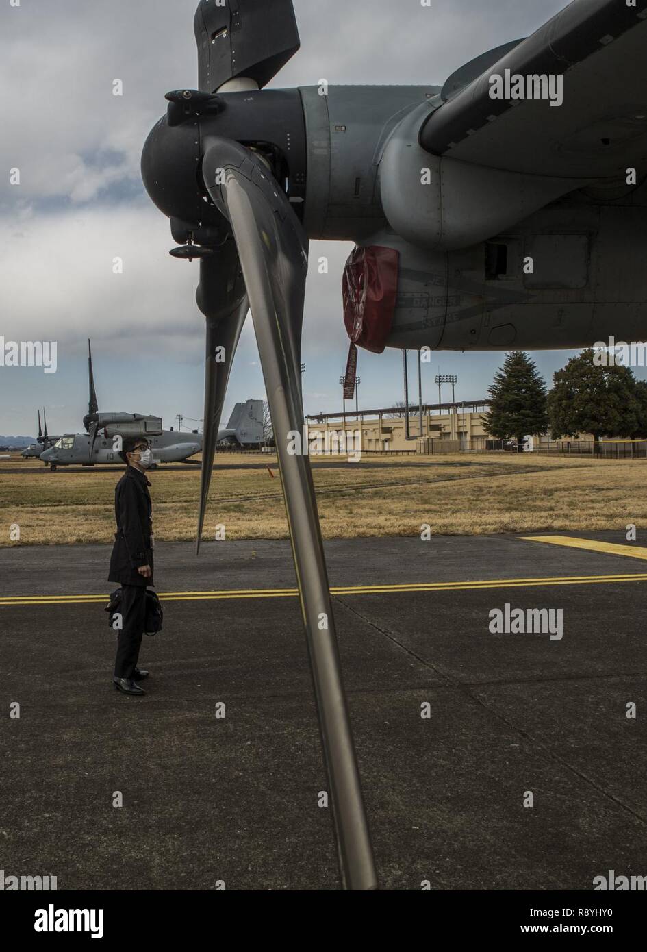 Deputy Director Kazuya Otsuki, part of the joint staff for the Japan Ministry of Defense, examines the blade of an MV-22B Osprey tiltrotor aircraft during a static display of the Osprey on Yokota Air Base, Japan, March 16, 2017 as part of Forest Light 17-1. Forest Light is a routine, semi-annual exercise conducted by U.S. and Japanese forces in order to strengthen our interoperability and combined capabilities in defense of the U.S.-Japanese alliance. Stock Photo