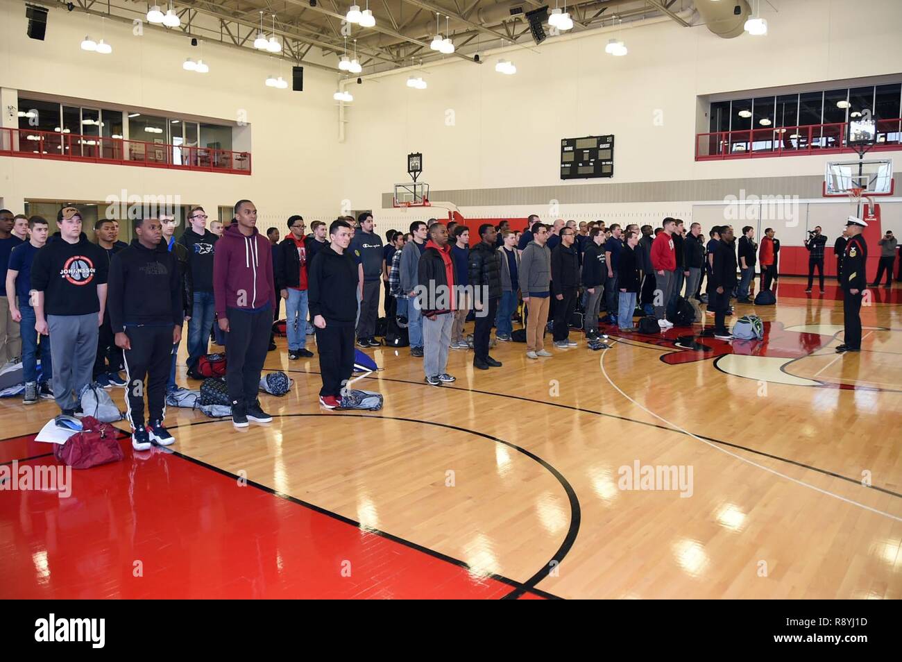 CHICAGO (March 14, 2017) Chief Hospital Corpsman Jaime Kalaw, right, a recruit division commander, brings a group of new recruits to attention in the Chicago Bulls practice facility. Eighty-four Chicago, Indiana, Wisconsin and Michigan future Sailors were sworn into the Navy at the facility. Stock Photo