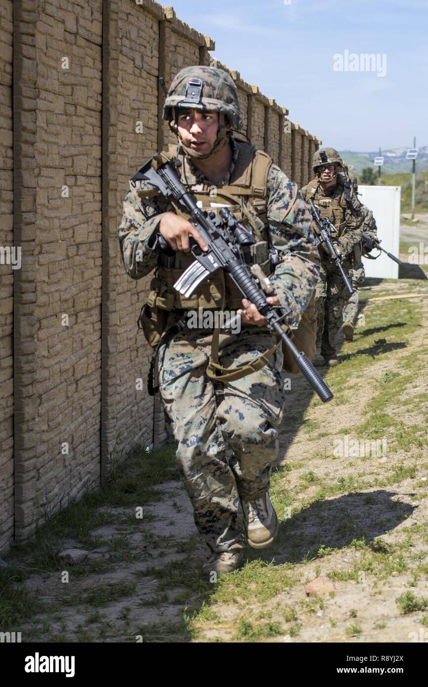 U.S. Marine Corps Cpl. Edgardo Gonzalez, rifleman, 3rd Battalion, 5th Marine Regiment buddy-rushes during a raid rehearsal at Camp Pendleton, Calif., March 16, 2017. Marines with 3rd Battalion, 5th Marine Regiment are training to maintain unit proficiency and preparing to deploy with the 15th Marine Expeditionary Force. Stock Photo