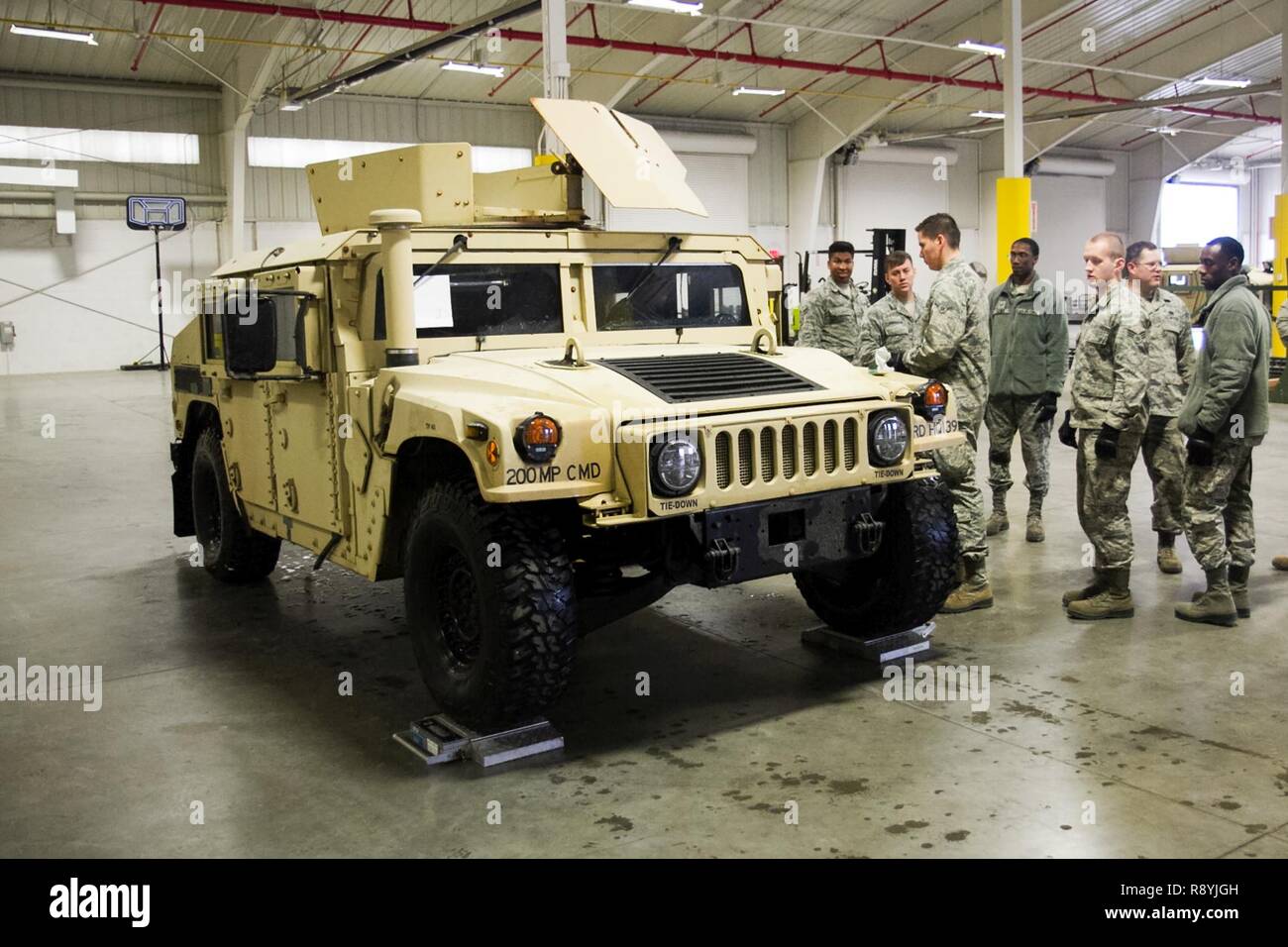 A U.S. Airmen prepare for a joint inspection an up-armored Humvee at Joint Base McGuire-Dix-Lakehurst, N.J., on March 18, 2017. The Airmen, who are assigned to the 621st Contingency Response Wing, spent the day with U.S. Army Reserve Soldiers from the 200th Military Police Command to inspect their up-armored Humvees in preparation for an air-land mission into Lakehurst Maxfield Field to kick off the ground operations of Warrior Exercise 78-17-01, which will be held March 8 to April 1, 2017. Roughly 60 units from the Army Reserve, Army, Air Force, Marine Reserves, and Canadian Armed Forces part Stock Photo