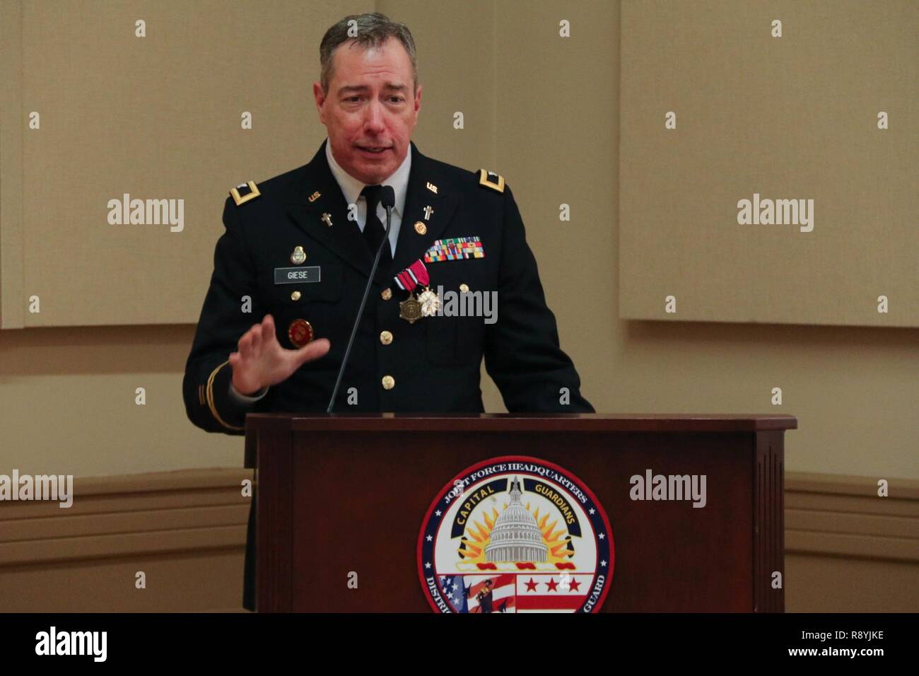 Chaplain (Col.) Samuel Giese, State Chaplain, D.C. National Guard, provides remarks at his retirement ceremony, Mar. 18, 2017 at the D.C. Armory, Washington, D.C. Giese retires after more than 35 years of military service. In his civilian ministry, Giese is pastor of Saint Jane Frances de Chantal Church in Bethesda, Md. Ordained a priest in 1985 for the Archdiocese of Washington, Giese served as associate pastor in several Washington area parishes followed by several years of prison ministry in the Washington, D.C. Department of Corrections at Lorton, VA and the Federal Bureau of Prisons. Stock Photo