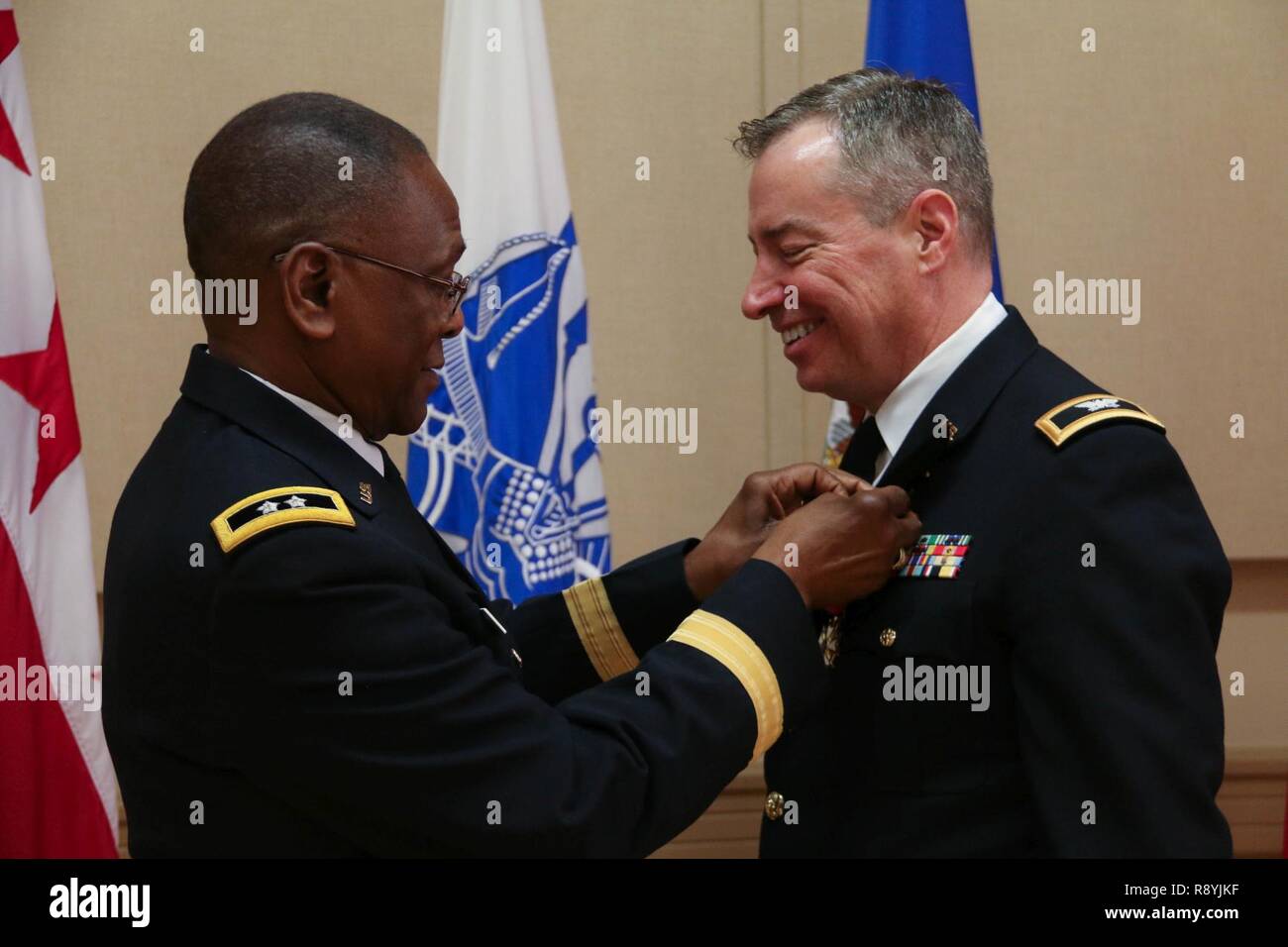 Maj. Gen.(Ret.) Errol R. Schwartz (left), former Commanding General, District of Columbia National Guard, affixes the Meritorious Service Medal onto Chaplain (Col.) Samuel Giese, State Chaplain, D.C. National Guard, at his retirement ceremony, Mar. 18, 2017 at the D.C. Armory, Washington, D.C. Giese retires after more than 35 years of military service. In his civilian ministry, Giese is pastor of Saint Jane Frances de Chantal Church in Bethesda, Md. Ordained a priest in 1985 for the Archdiocese of Washington, Giese served as associate pastor in several Washington area parishes followed by seve Stock Photo