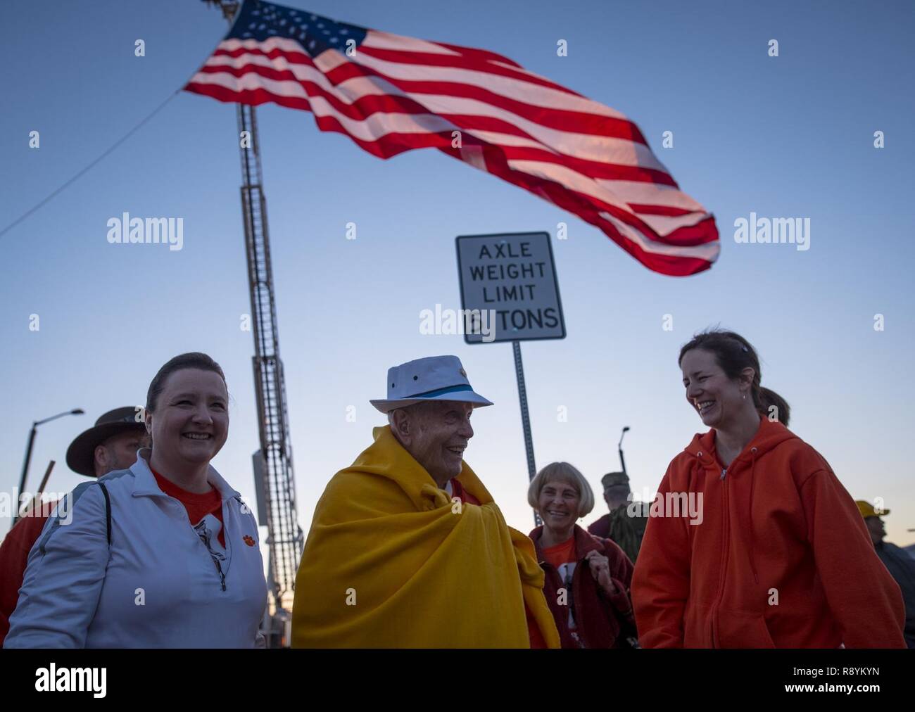 Retired U.S. Army Col. Ben Skardon, 99 (center), a survivor of the Bataan Death March, jokes with some of his loyal support team, Ben’s Brigade, before the start of the 28th annual Bataan Memorial Death March at White Sands Missile Range, N.M., March 19, 2017. Stock Photo