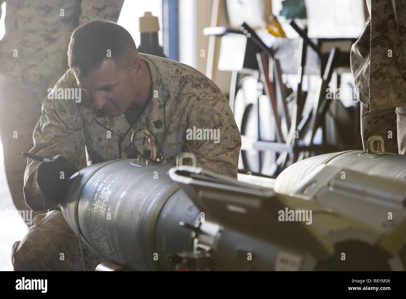 U.S. Marine Corps Staff Sgt. Jeffrey W. Stiles, an aviation ordnance system technician with Marine Aviation Logistics Squadron 13 (MALS-13) gives a period of instruction on the Guided Bomb Unit 12 (GBU-12) during the first ever Aircraft Maintenance Officer Course (AAMOC) at Marine Corps Air Station Yuma, Ariz., March 17, 2017. AAMOC will empower Aircraft Maintenance Officers with leadership tools, greater technical knowledge, and standardized practices through rigorous academics and hands on training in order to decrease ground related mishaps and increase sortie generation. Stock Photo
