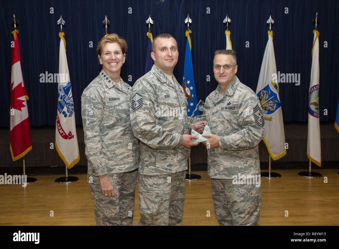NORAD ( North American Aerosapce Defense Command) Commander Lori Robinson and Chief Master Sgt. Harold Hutchinson, right, NORAD's Senior Enlisted Leader present the NORAD Senior Noncomisioned Officer of the Year award to Master Sgt James Burke, a member of the 224th Air Defense Group of the New York Air National Guard, on March 14, 2017 during a ceremony at NORAD headquarters on Colorado Springs, CO. The 224th Air Defense Group is manned by New York Air National Guard Airmen and is a component of the Easter Air Defense Sector which coordinates air defense for the United States east of the Miss Stock Photo