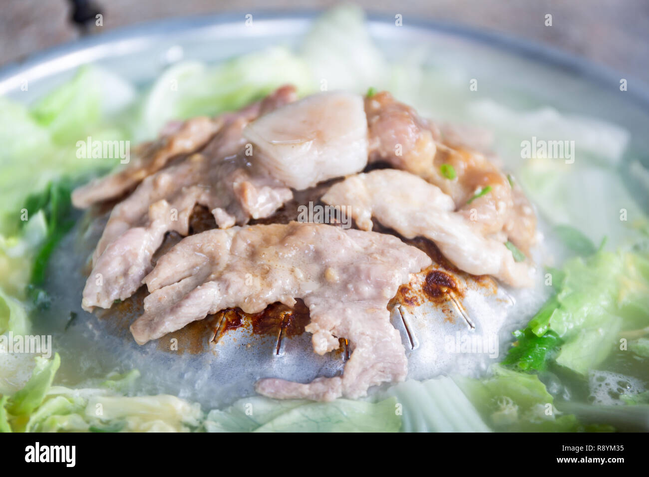 Thai barbecue buffet grill pork on hot pan or Thai BBQ buffet (Moo Kra Ta), Thai food style. Stock Photo