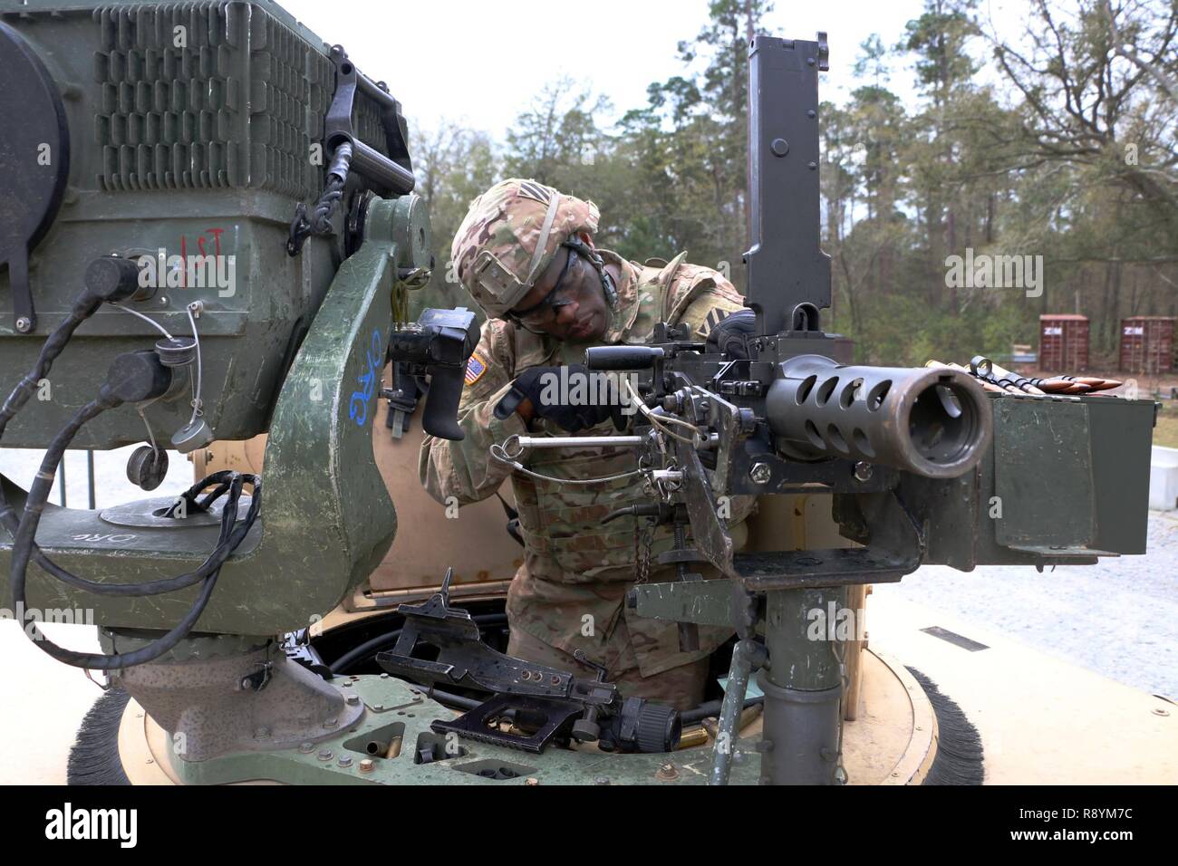 Sgt. John Onuoha, team leader with Bravo Troop, 6th Squadron, 8th Cavalry Regiment, 2nd Infantry Brigade Combat Team, 3rd Infantry Division, disassembles an M2 .50 caliber machine gun during a mounted gunnery range March 8, 2017 at Fort Stewart, Ga. 6-8 Cav. Soldiers qualified with their mounted weapons in preparation for a squadron field training exercise next month. Stock Photo