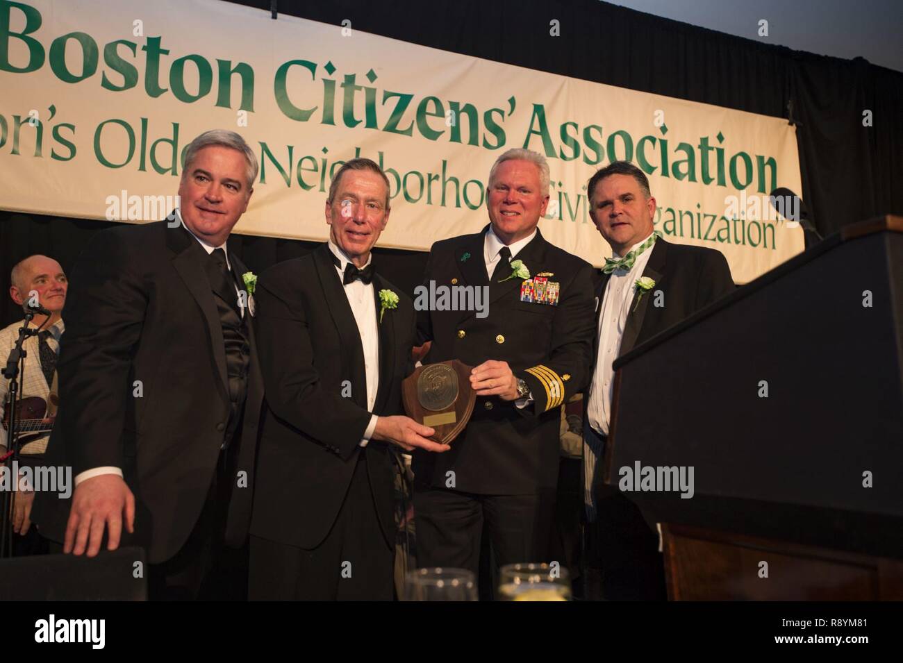 BOSTON (March 17, 2017) USNS Comfort (T-AH 20) Commanding Officer, Capt. Lanny Boswell, presents a gift to the South Boston Citizen’s Association at their Evacuation Day Banquet. Comfort participated in festivities and community programs throughout the city as part of Boston's St. Patrick’s Day celebration. Stock Photo
