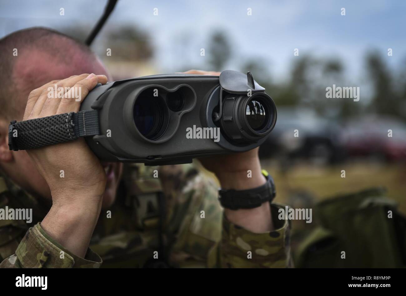 A Soldier with the 1st Battalion, 10th Special Forces Group, uses a laser rangefinder at the Eglin Range, Eglin Air Force Base, Fla., March 17, 2017. Soldiers use the laser rangefinder to identify target location distance, day or night, and with limited visibility such as fog or smoke. Stock Photo