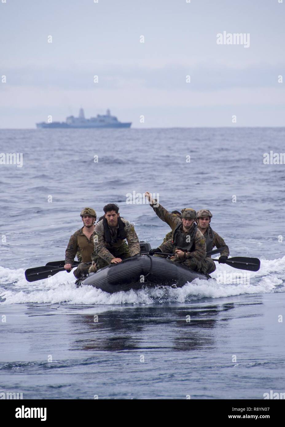 PHILIPPINE SEA (March 19, 2017) Reconnaissance Marines, assigned to the Maritime Raid Force (MRF) of the 31st Marine Expeditionary Unit (MEU), navigate a combat rubber raiding craft (CRRC) into the well deck of amphibious assault ship USS Bonhomme Richard (LHD 6) following a helo cast exercise. A helo cast is a method used to insert reconnaissance and surveillance teams for amphibious reconnaissance missions requiring small boat operations. Bonhomme Richard, flagship of the Bonhomme Richard Expeditionary Strike Group, with embarked 31st MEU, is on a routine patrol, operating in the Indo-Asia-P Stock Photo