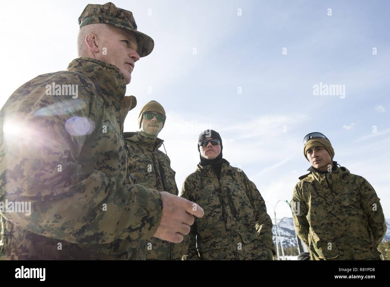 U.S. Marine Corps Sgt. Maj. Bradley Kasal, I Marine Expeditionary Force sergeant major, speaks with Marines from 1st Combat Engineer Battalion (CEB), 1st Marine Division, during Mountain Training Exercise (MTX) 2-17 at the Marine Corps Mountain Warfare Training Center, Bridgeport, Calif., Mar. 16, 2017. 1st CEB completed the final exercise of MTX 2-17, a three-part cycle consisting of avalanche initiation, ice breaching, obstacle emplacement and tree cutting using explosives. Stock Photo