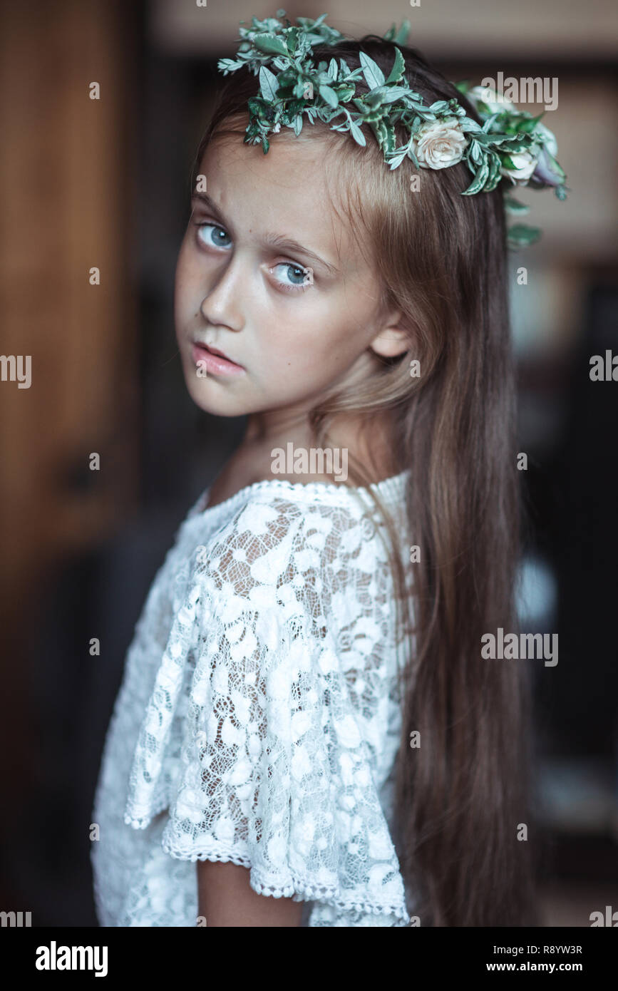 cute girl with very long hair and a beautiful wreath of flowers on her ...