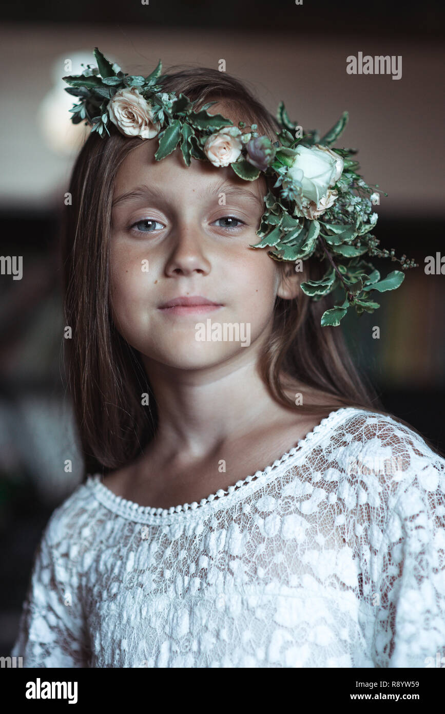 cute girl with very long hair and a beautiful wreath of flowers on her ...