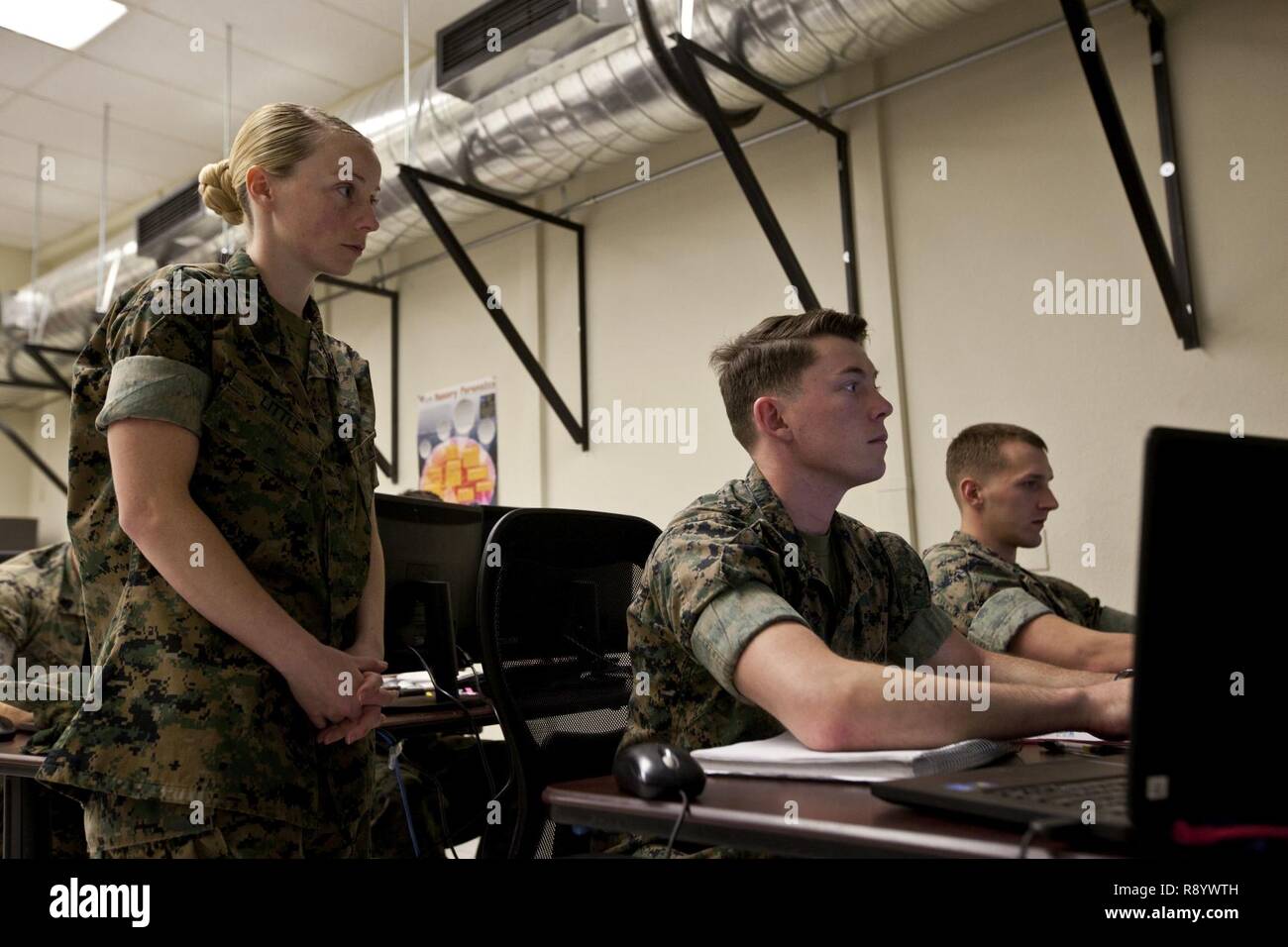 U.S. Marine Corps Gunnery Sgt. Amanda K. Little, left, an instructor  assigned to the Cyber Security Technician course, Marine Corps  Communications-Electronics School, supervises students during a period of  instruction at Marine Corps
