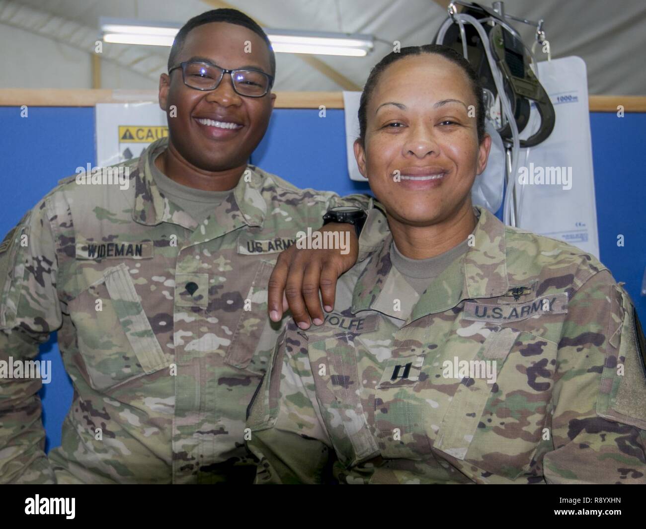 Capt. Andrea Wolfe, senior brigade physician assistant, and her son Spc. Kameron Wideman, a behavioral health technician, both assigned to the Brigade Support Medical Company, 215th Brigade Support Battalion, 3rd Armored Brigade Combat Team, 1st Cavalry Division, are deployed for nine months to Camp Buehring, Kuwait. 'We are passionate about the military,' Wolfe said. 'This is our Army.' Stock Photo