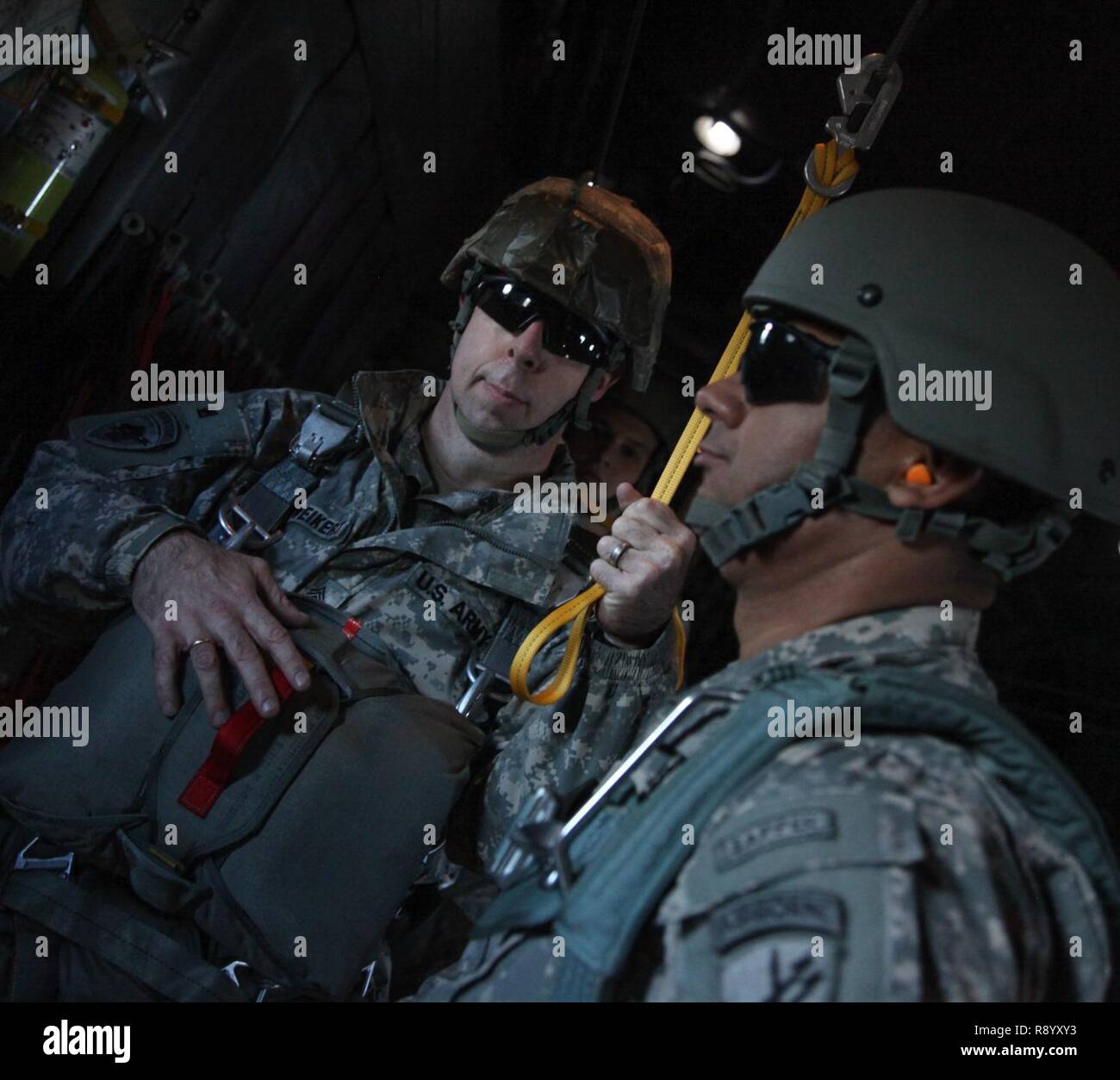 U.S. Army paratroopers, Sgt. 1st Class Paul Schweikert and Master Sgt. Hermin Sarantes, prepares to exit a C-130 during a standard Airborne Operation for currency over Preston Drop Zone, Augusta, Ga., March 3, 2017. Paratroopers must jump once every three months to maintain their jump status. Stock Photo