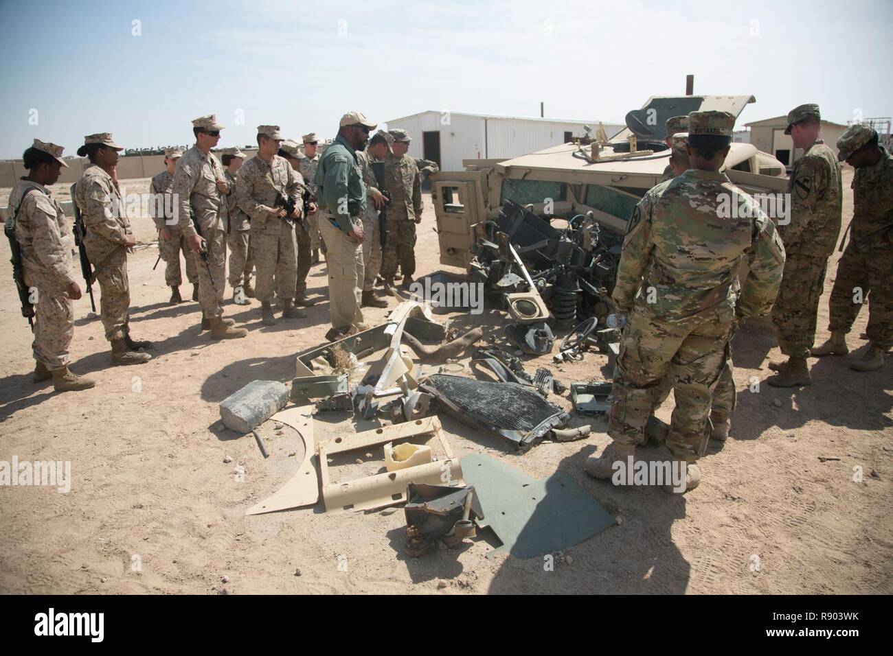 CAMP BEUHRING, Kuwait (Mar. 1, 2017) U.S. Marines with Combat Logistics Battalion 11, 11th Marine Expeditionary Unit (MEU), and soldiers with 3rd Armored Brigade Combat Team, 215th Brigade Support Bn., assess damage sustained on a tactical vehicle from an improvised explosive device during counter IED training as part of a sustainment training exercise at Camp Beuhring, Kuwait, Mar. 1. Counter IED measures are organized to aid in identifying and properly disposing of IEDs. SUSTEX provided the MEU additional training repetitions to reinforce combat skills as they make their way through the U.S. Stock Photo