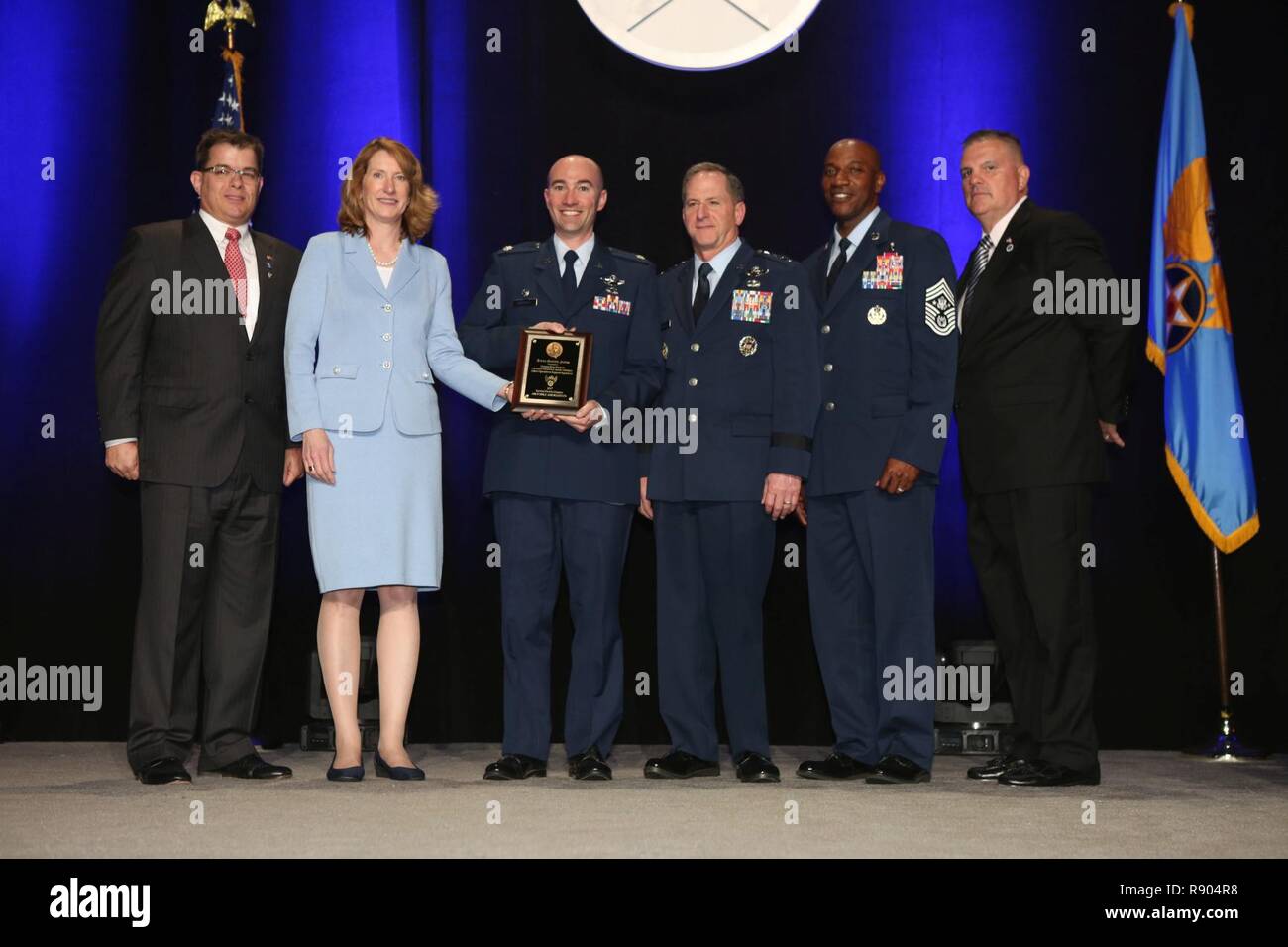 Lt. Col. Scott, former 432nd Operations Support Squadron commander, accepts the inaugural Jimmy Doolittle Educational Fellow for Outstanding Support to Armed UAVs March 2, 2017, at the Martin H. Harris Chapter of the Air Force Association Air Force Gala banquet in Orlando, Florida. Acting Secretary of the Air Force, Lisa Disbrow, presented the award alongside, from left, Air Force Gala Chairman Michael Liquori, Chief of Staff of the Air Force Gen. David Goldfein, Chief Master Sgt. of the Air Force Kaleth Wright and Martin H. Harris Chapter President Gary Lehmann. Stock Photo