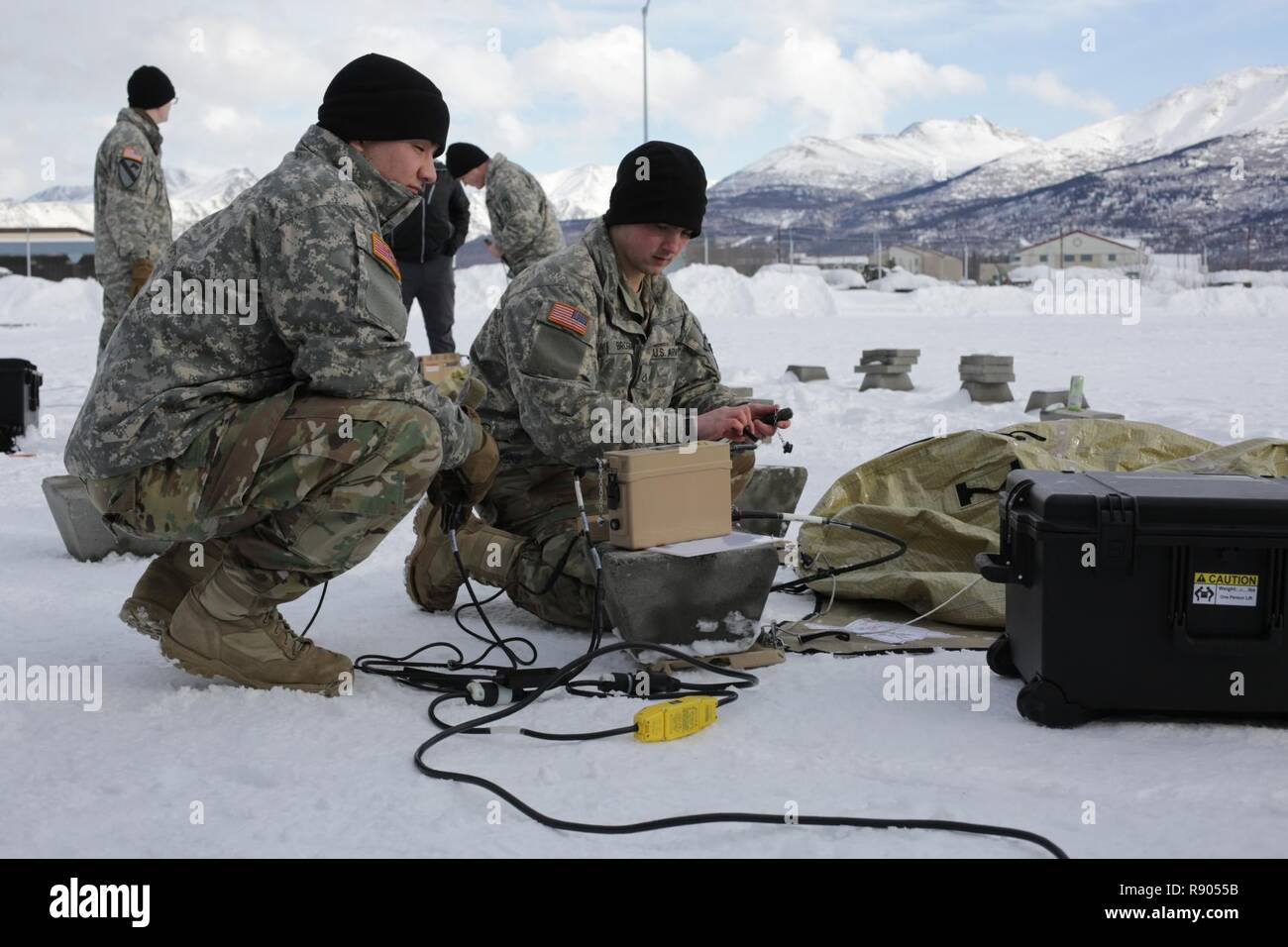 Pfc. Connor Anderson (left), a Human Intelligence Collector, and Pfc. Austin Brogan, a Signals Intelligence Analyst, both with Company D, 6th Brigade Engineer Battalion, 4th Infantry Brigade Combat Team (Airborne), 25th Infantry Division, prepare to set up the Transportable Tactical Command Communications (T2C2) during an operational test of the system at Joint Base Elmendorf-Richardson, Alaska. T2C2 is a new Army program of record that when fielded will provide agile robust voice and data communications in the early phases of joint operations and in later operational phases at the tactical ed Stock Photo