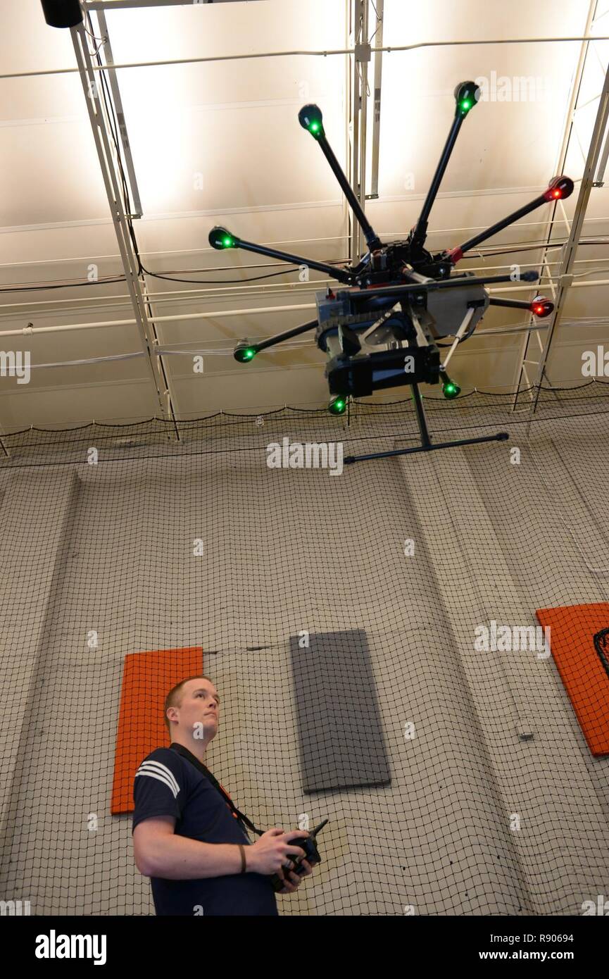 Brent McLaughlin demonstrates a drone automated payload swap system from Employees of Endeavor Robotics and Asylon during the ThunderDrone Rodeo at the newest SOFWERX facility in Tampa, Fla., Oct. 31, 2017. ThunderDrone is a U.S. Special Operations Command initiative dedicated to drone prototyping, which focuses on exploring drone technologies through idea formation, testing, and demonstration. Stock Photo