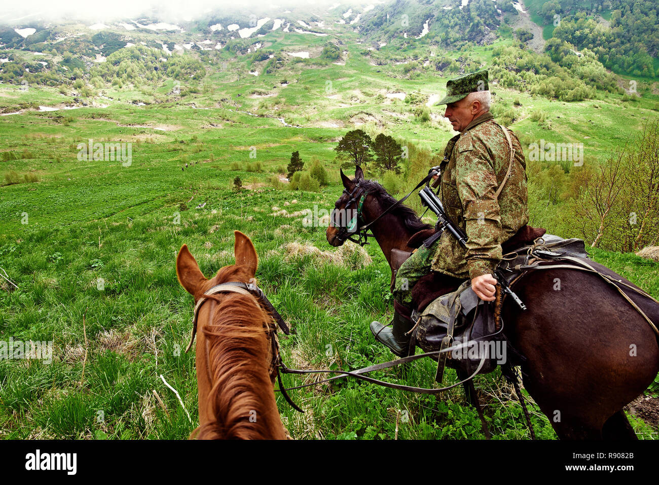 Krasnodar, RUSSIA - July 17, 2015: Huntsman is a horse in the mountains. Stock Photo