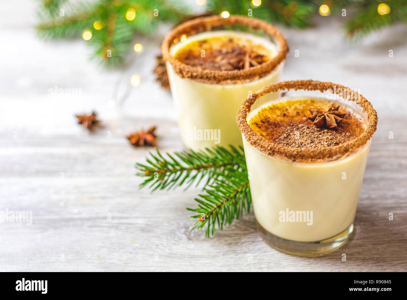 Eggnog with cinnamon and nutmeg for Christmas and winter holidays. Homemade  eggnog in glasses on wooden table surface, shallow depth of the field, cop  Stock Photo - Alamy