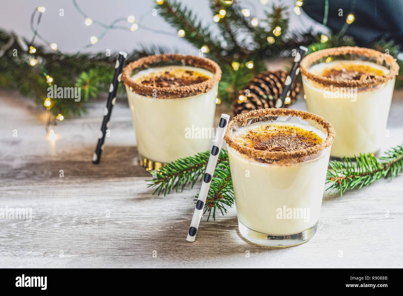 https://c8.alamy.com/comp/R9088B/eggnog-with-cinnamon-and-nutmeg-for-christmas-and-winter-holidays-homemade-eggnog-in-glasses-on-wooden-table-surface-shallow-depth-of-the-field-cop-R9088B.jpg