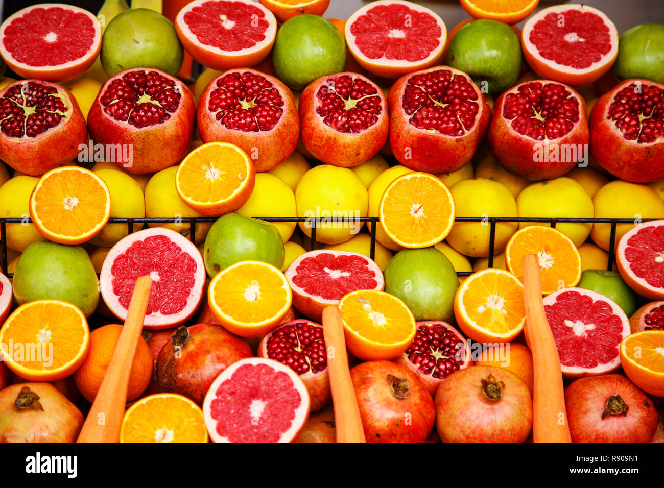 Ripe and juicy half fruit ready for making juice. Bright fruit background. Stock Photo