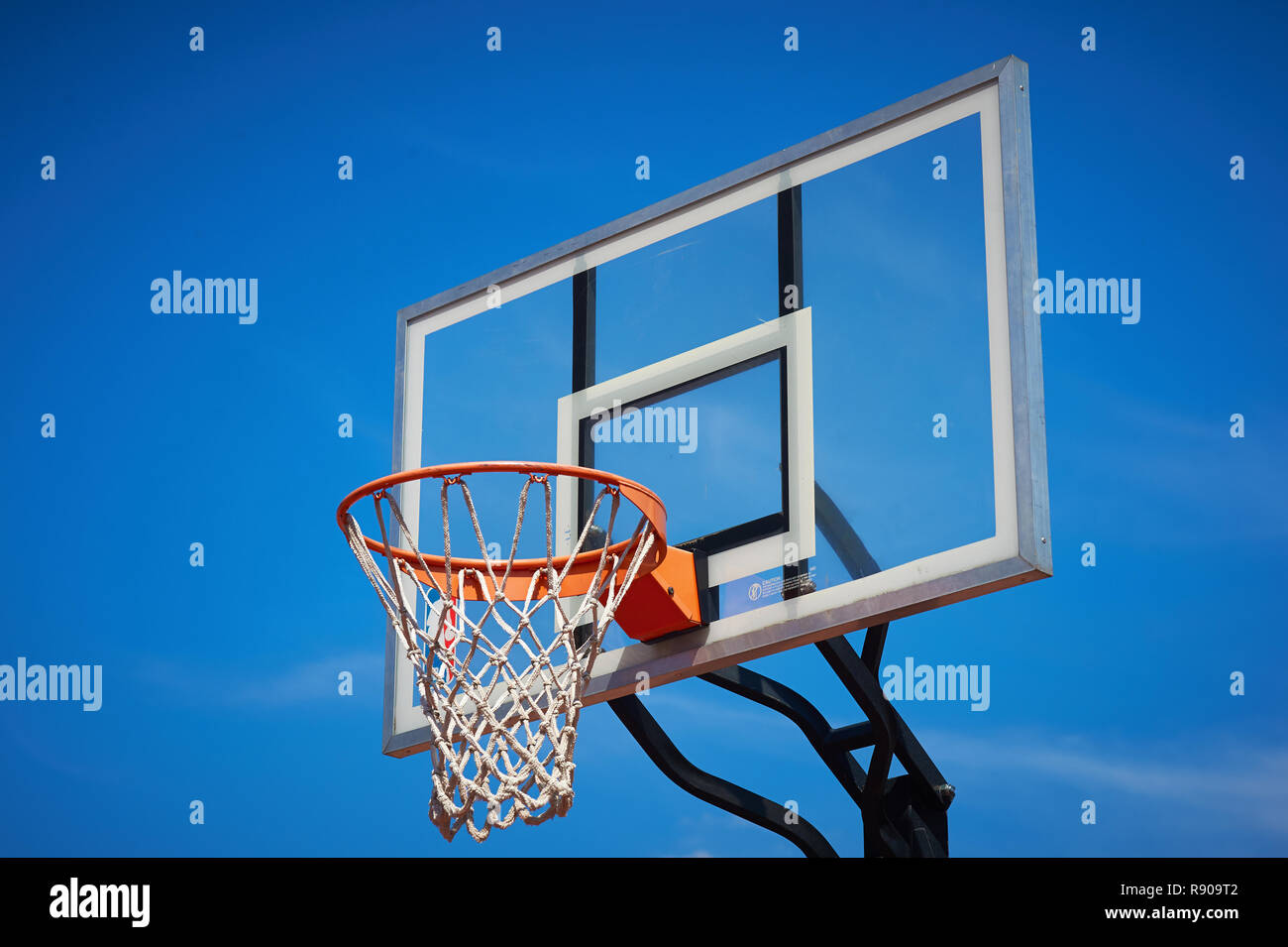 Basketball hoop and backboard with blue sky. Stock Photo