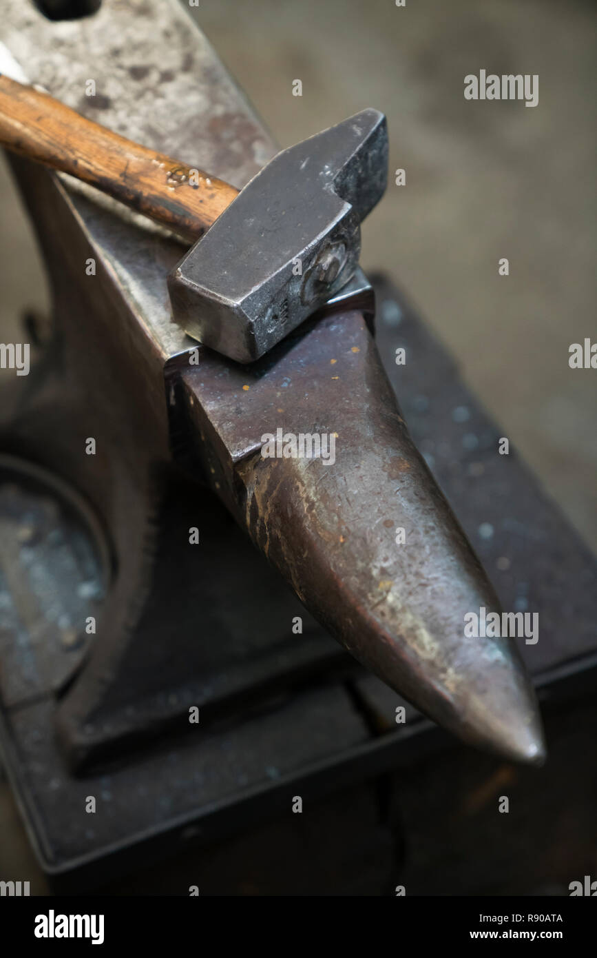 Still life of an anvil and a hammer in a blacksmith's metalwork shop ...