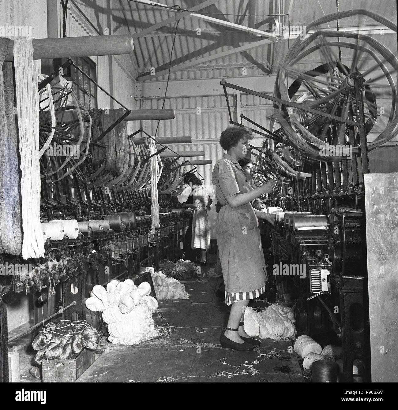 1950s, historical, female workers standing using machinery at weaving