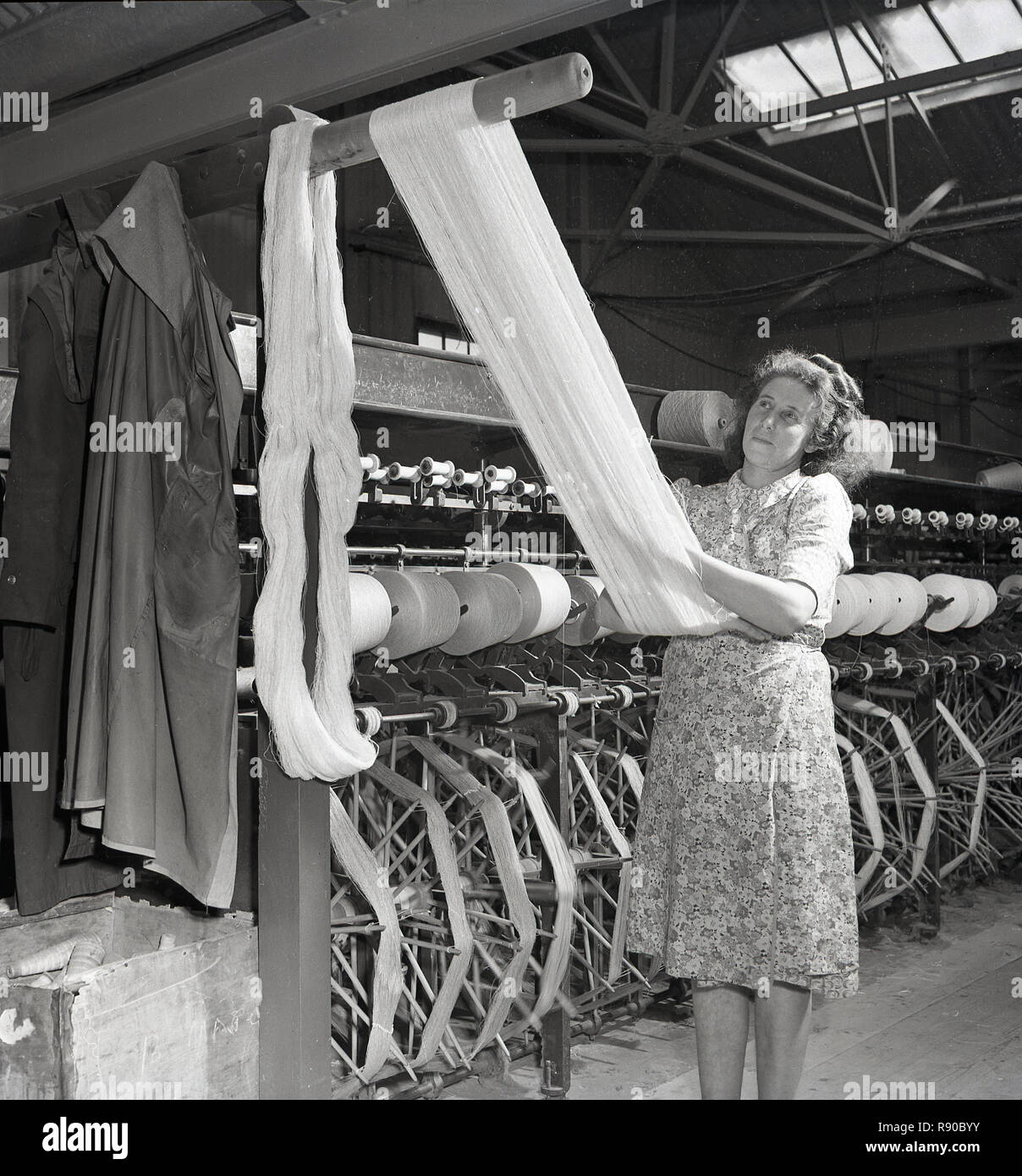 1950s, historical, inside a linen factory, a female worker in a