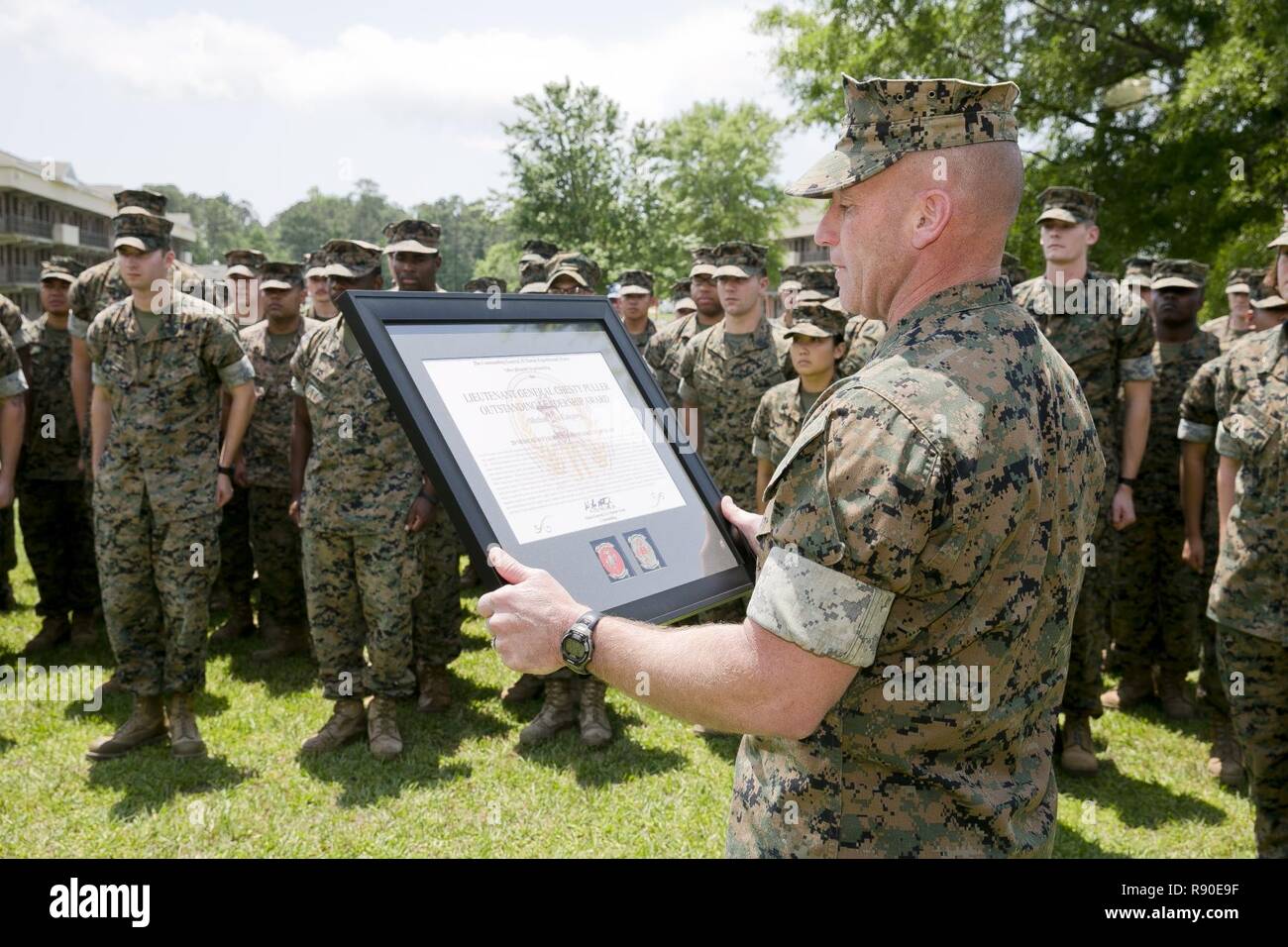 U.S. Marine Corps Sgt. Maj. Richard D. Thresher, sergeant major, II Marine Expeditionary Force (II MEF), reads the citation for the “Lt. Gen. Chesty Puller” Outstanding Leadership Award as it is being presented to the Marines and Sailors of 2nd Medical Battalion, II MEF, Camp Lejeune, N.C., May 10, 2017. The battalion earned this award for exceptional professional ability, superior performance and dedication to supporting the mission of the II MEF. Stock Photo