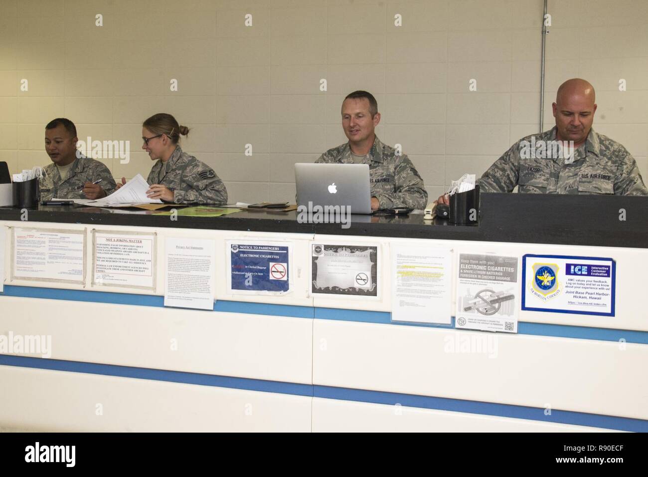 Air Force Reserve Citizen Airmen Staff Sgts. Ken Camacho, of Hagatna, Guam, Jessica Gwinn, of Dover, Del., Chad Vazquez, of Austin, Texas, and Paul Lazor, of Honolulu, Hawaii, air transportation specialists with the 48th Aerial Port Squadron, input passenger information for a Space Available Travel flight at Joint Base Pearl Harbor-Hickam, Hawaii, March 11, 2017. Members of the 48th Aerial Port Squadron support the Space A Travel program during their two-week annual training and monthly unit training assembly. Located on Oahu and a component of the Air Force Reserve, the 48th Aerial Port Squad Stock Photo