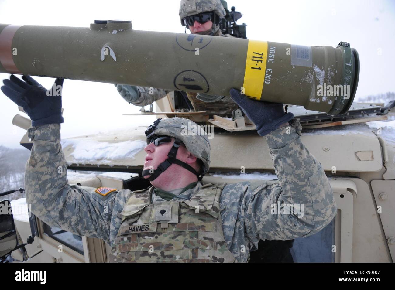 U.S. ArmySpc. Mike McGuire loads a TOW missile at Fort McCoy, Wis., on March 13, 2016. The  BGM-71 TOW is a Tube-launched, Optically tracked, Wire-guided  anti-tank missile currently manufactured by Raytheon. Stock Photo