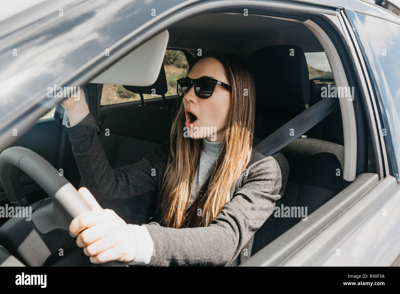 The Girl Or The Driver In The Car Is Surprised Or Scared Or - 