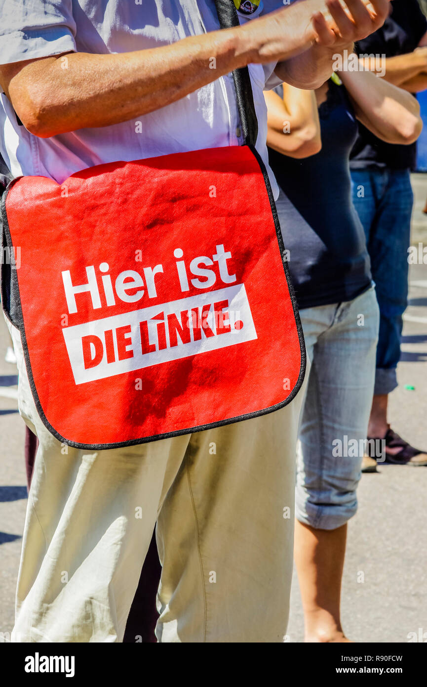 middle aged man with shoulderbag bearing the inscript: 'hier ist DIE LINKE' Stock Photo