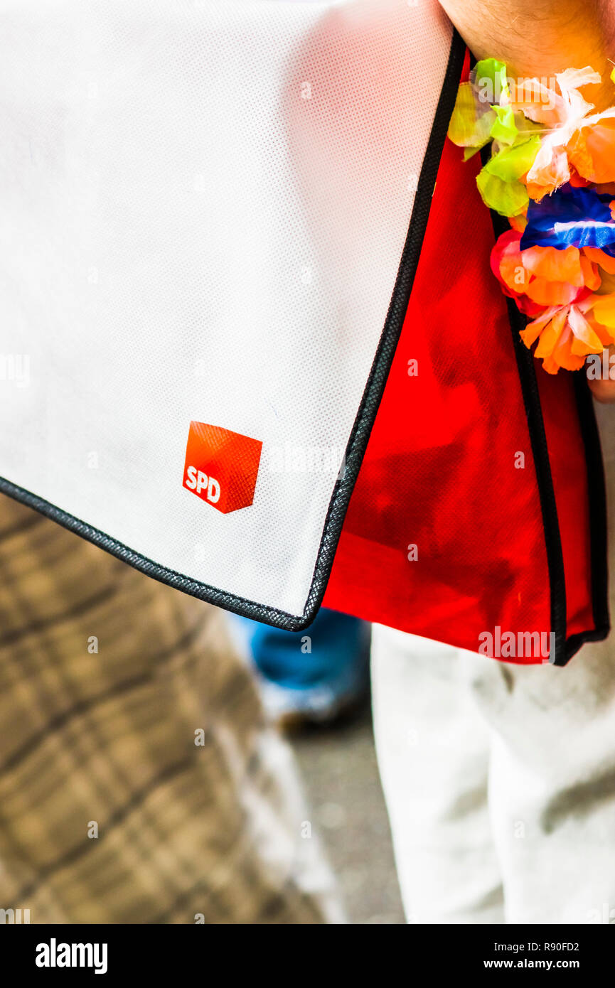 young man carrying a  red shoulder bag with a white cover that displays the logo of the german political party SPD, social democratic party of germany Stock Photo