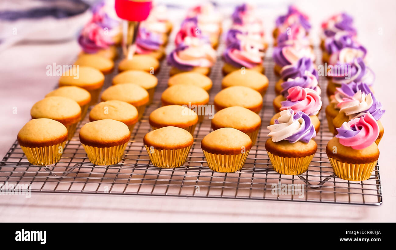 Step by step. Scooping batter with a cupcake scoop to make unicorn  chocolate cupcakes with buttercream frosting Stock Photo - Alamy