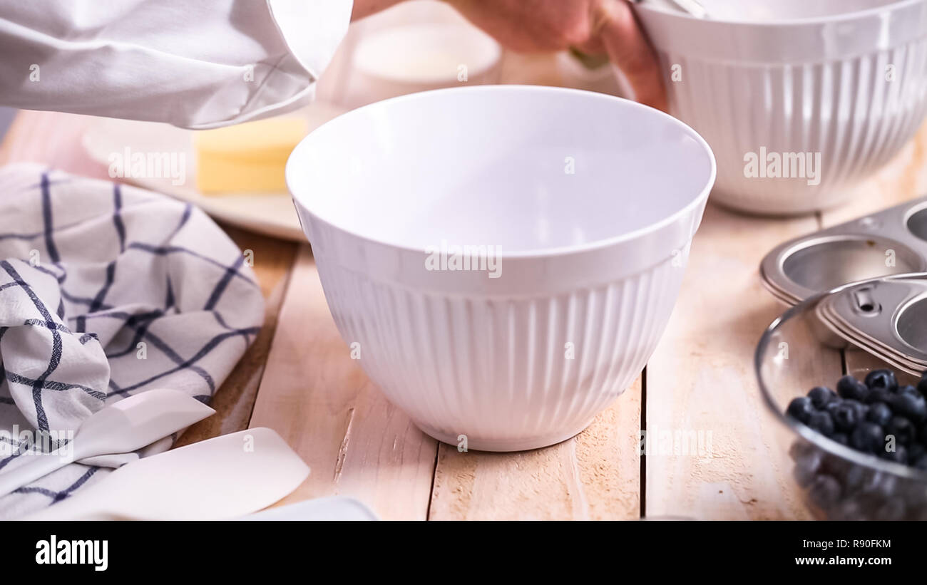 Mixing ingredients together in mixing bowl for blueberry muffins Stock