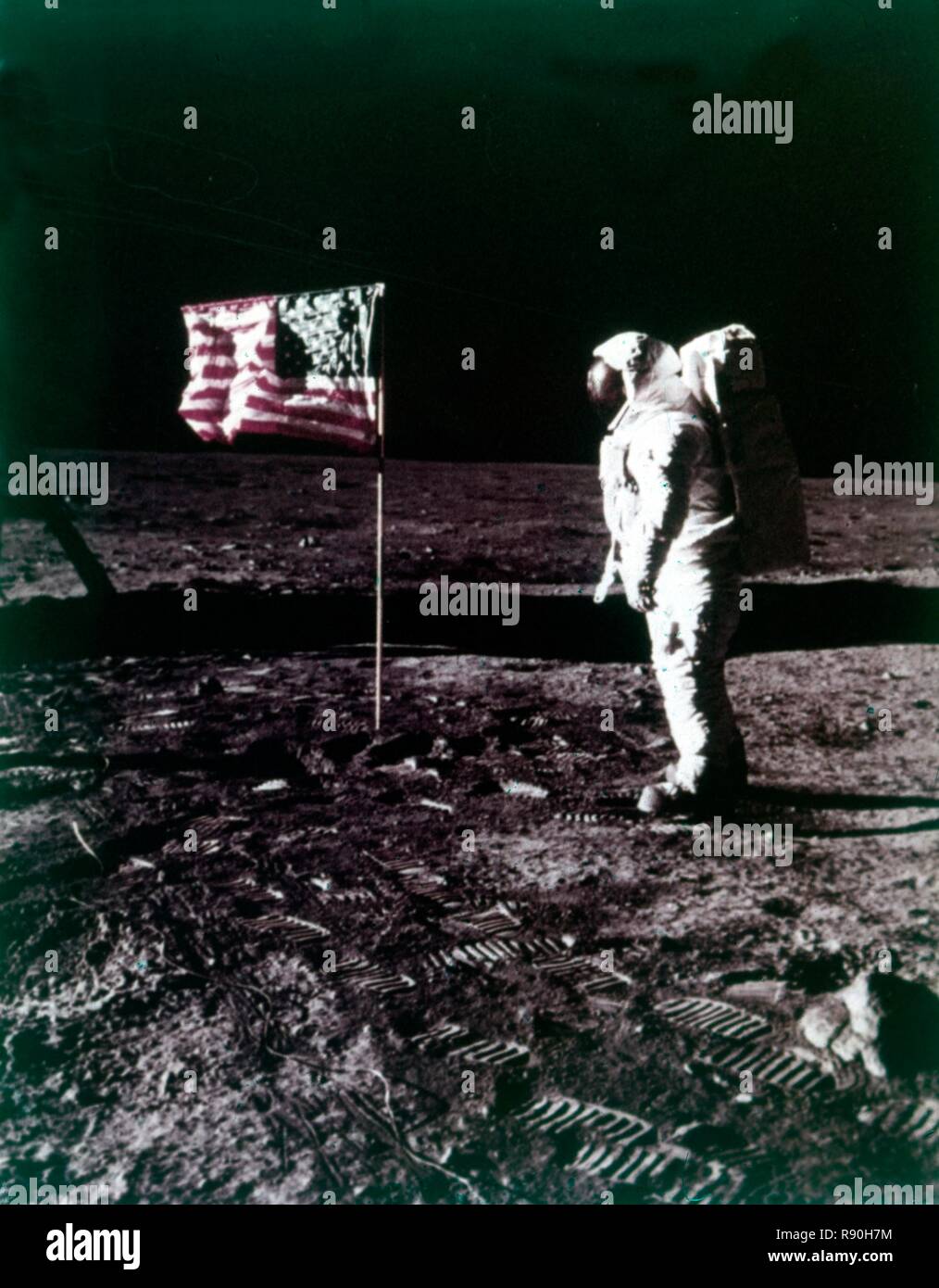 Buzz Aldrin stands next to the American flag on the surface of the Moon, July 1969. Creator: Neil Armstrong. Stock Photo