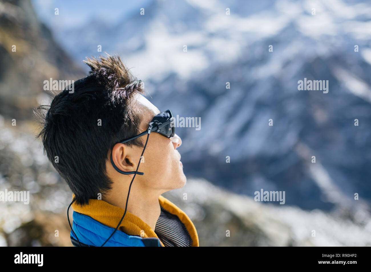 Profile portrait of young Asian ethnic mountaineer in the Himalaya