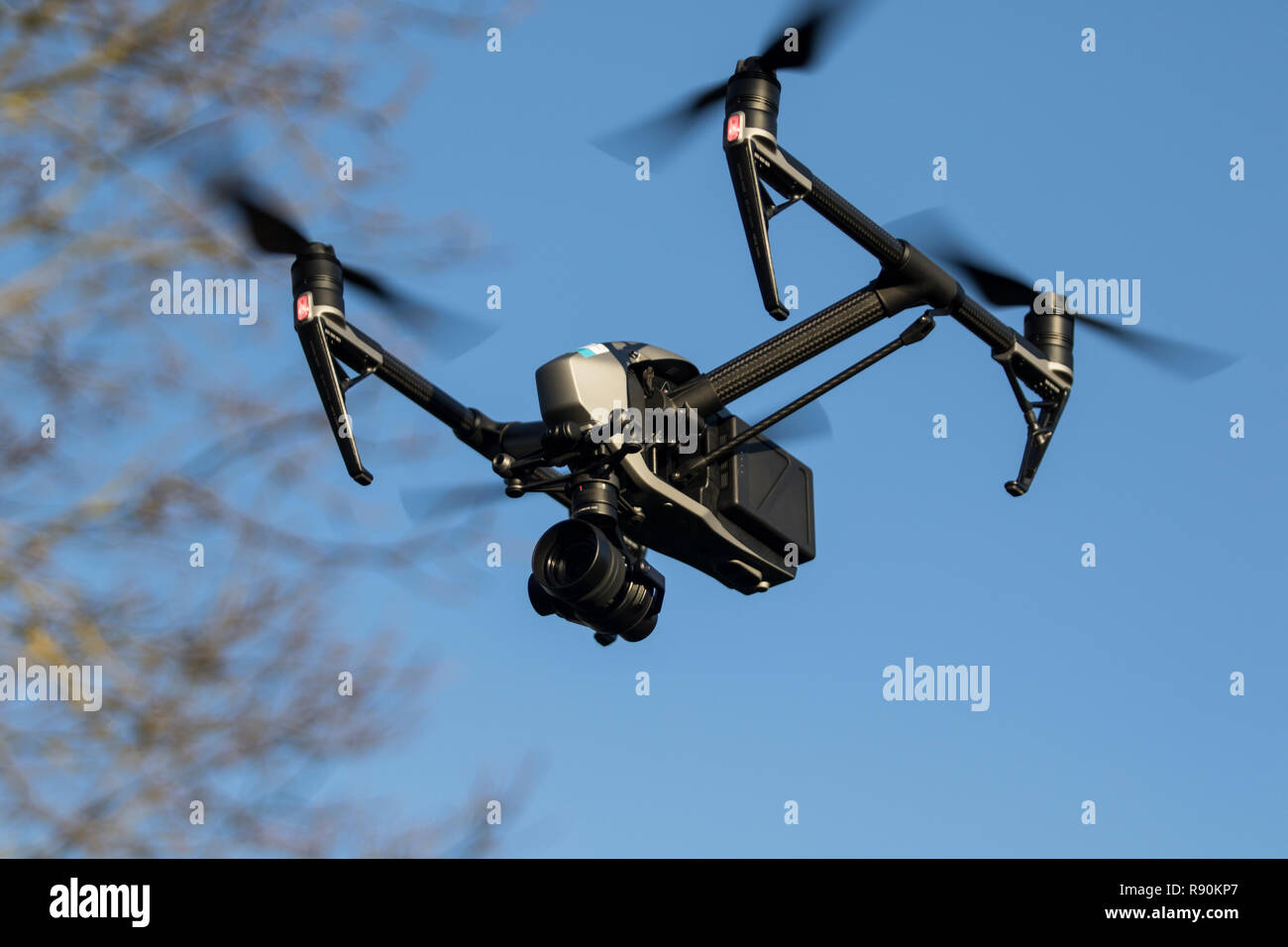 Drone flying in the air against trees and blue sky- DJI Inspire 2 Stock Photo