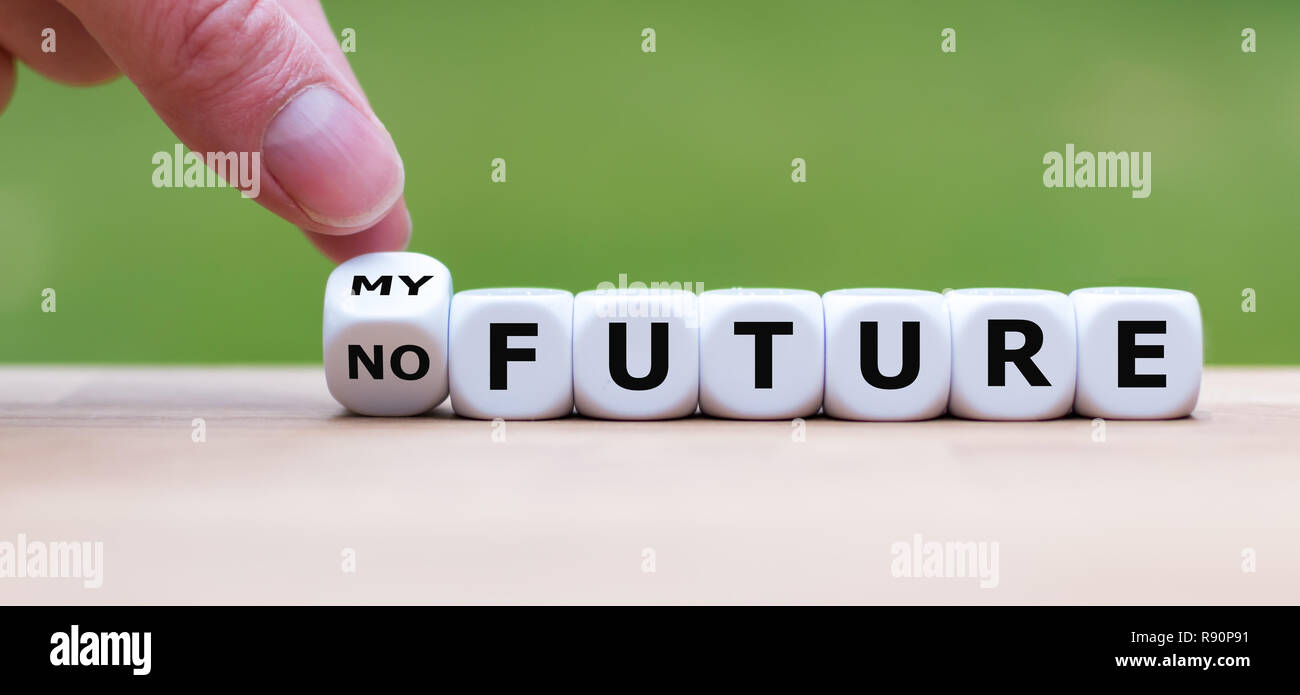 Hand is turning a dice and changes the expression 'no Future' to 'my Future' Stock Photo