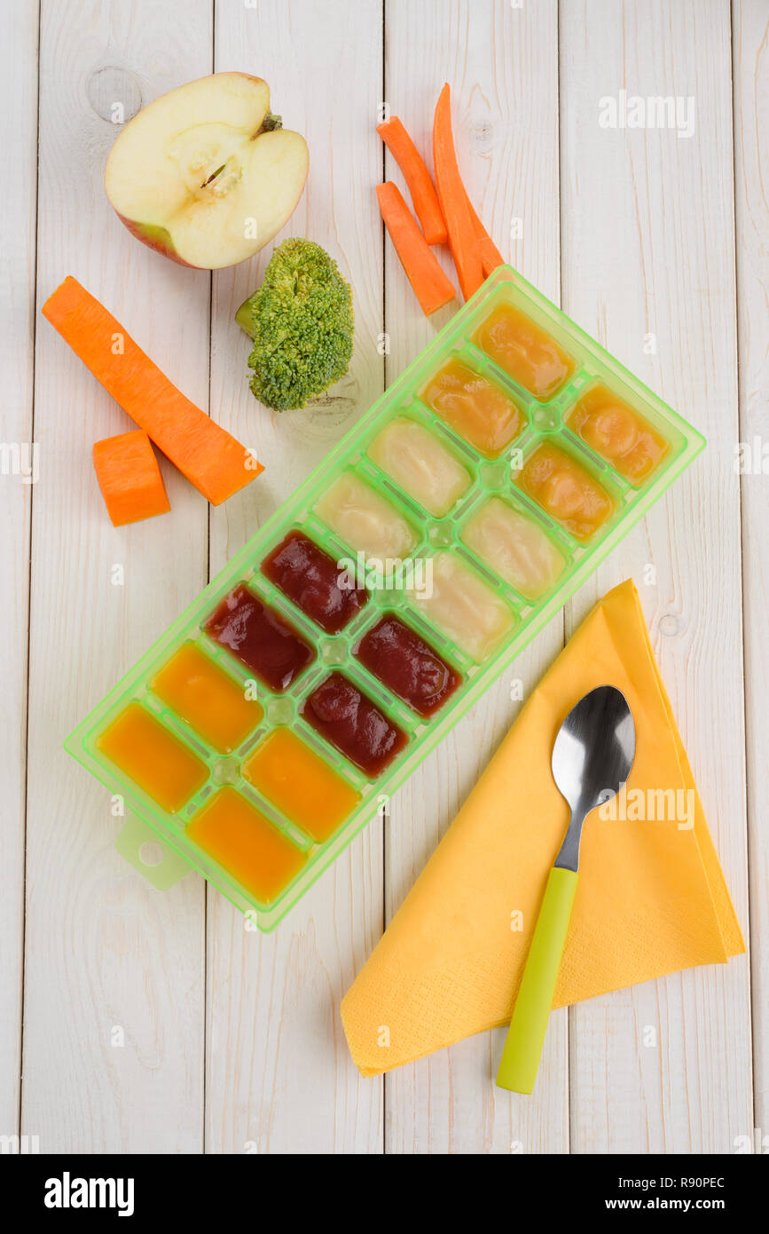 Natural ingredients, assorted puree in a tray container and spoon with ...