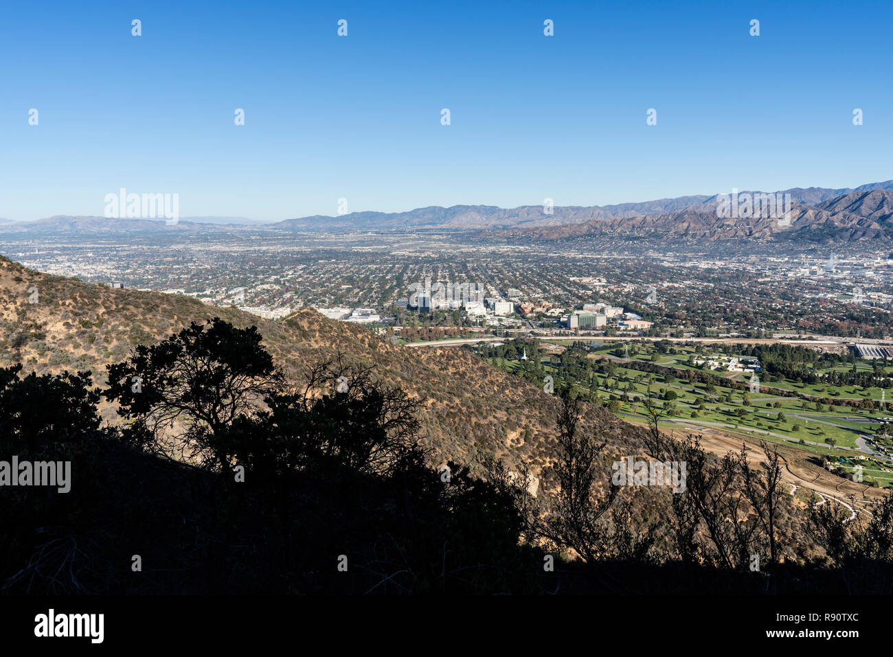 Burbank and the San Fernando Valley with the Verdugo Hills and San Gabriel Mountains in background.  Shot from Griffith Park hiking trail in Los Angel Stock Photo