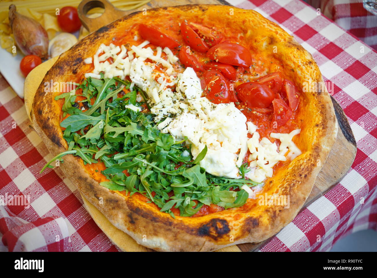 Patriotic Italian tricolore pizza with stripes of red, white and green in the colours of the national flag Stock Photo