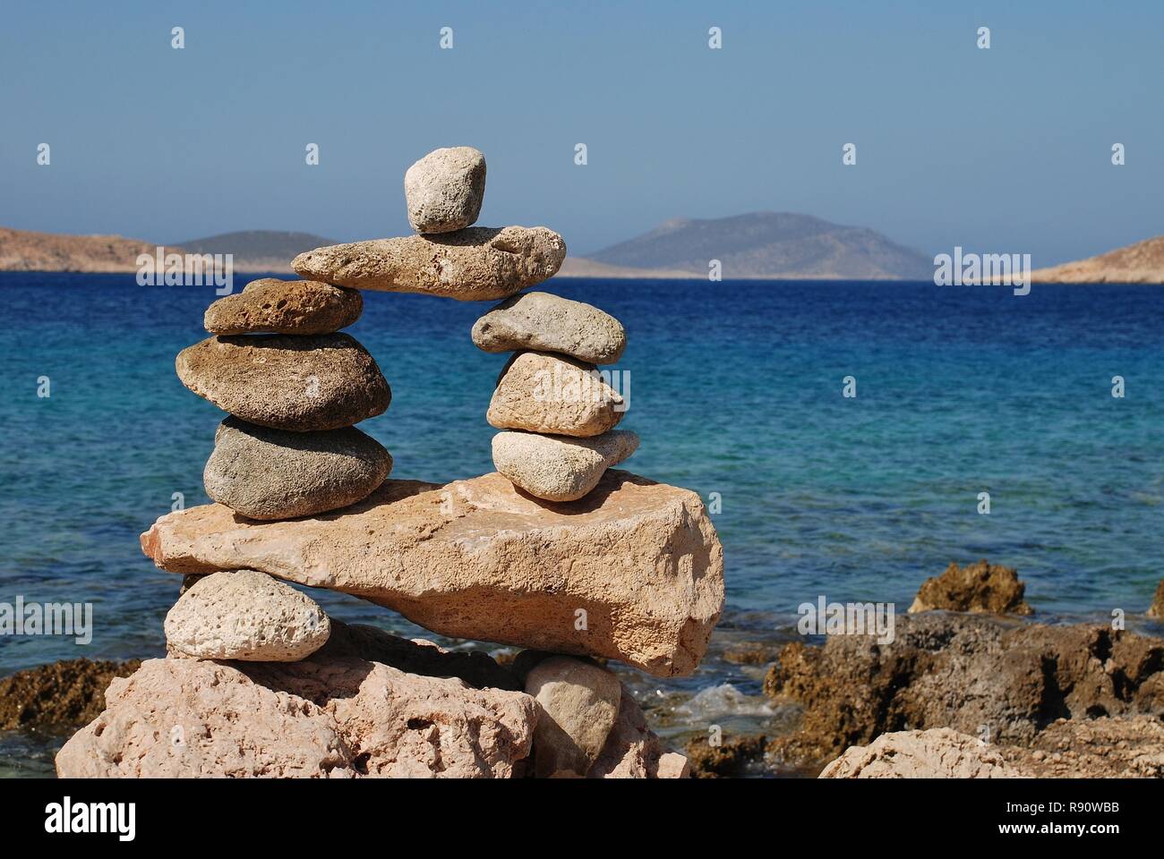 A tower of stones on Ftenagia beach at Emborio on the Greek island of Halki. Stock Photo